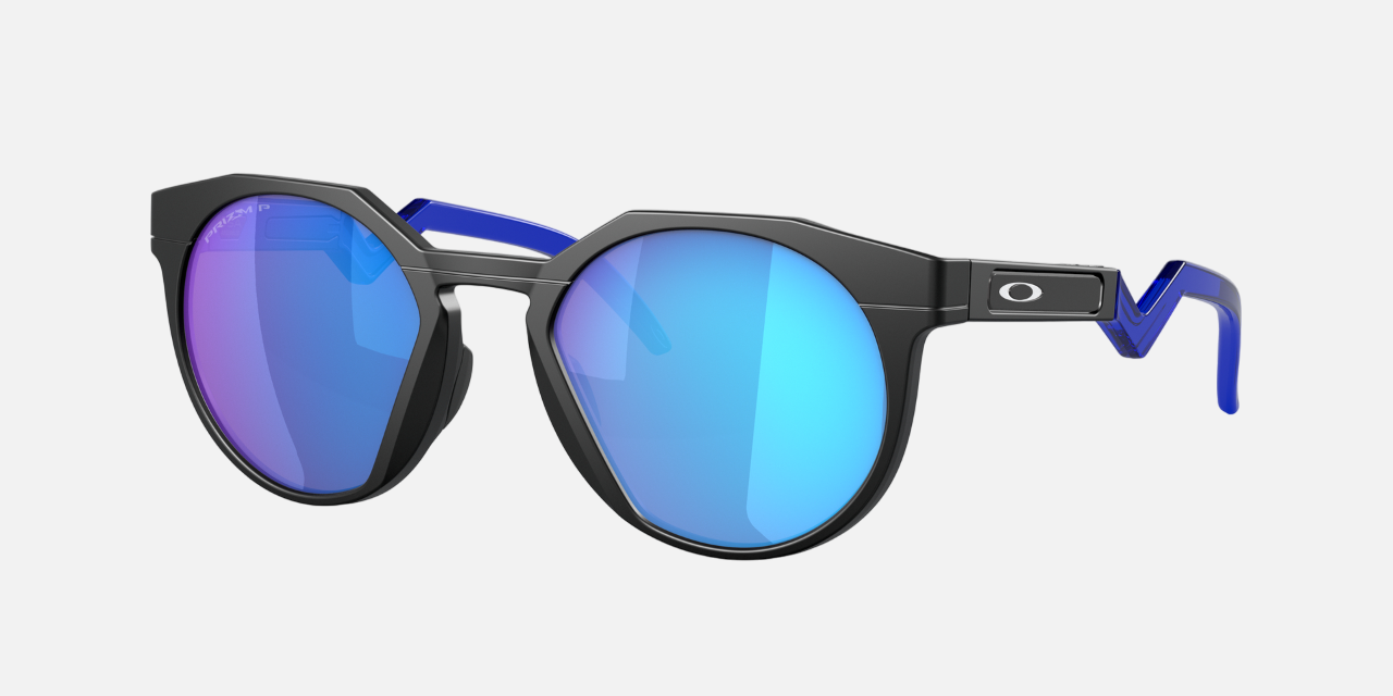 Oakley Hstn 04 round sunglasses for men in full rim plastic, with black frame, and blue lenses. 52mm in lens size, 21mm in bridge size, and 142mm in temple length.