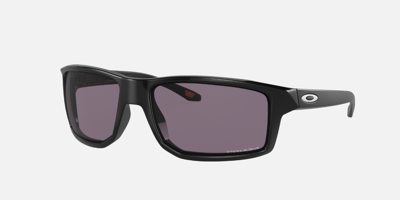 Oakley Gibston 01 rectangular sunglasses for men in full rim plastic, with black frame, and grey lenses. 60mm in lens size, 17mm in bridge size, and 132mm in temple length.