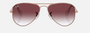 Ray-Ban Junior Aviator Kids RJ9506S 291/8H pilot sunglasses for kids in full rim metal, with polished rose gold frame, and gradient dark violet lenses. 52mm in lens size, 14mm in bridge size, and 125mm in temple length.