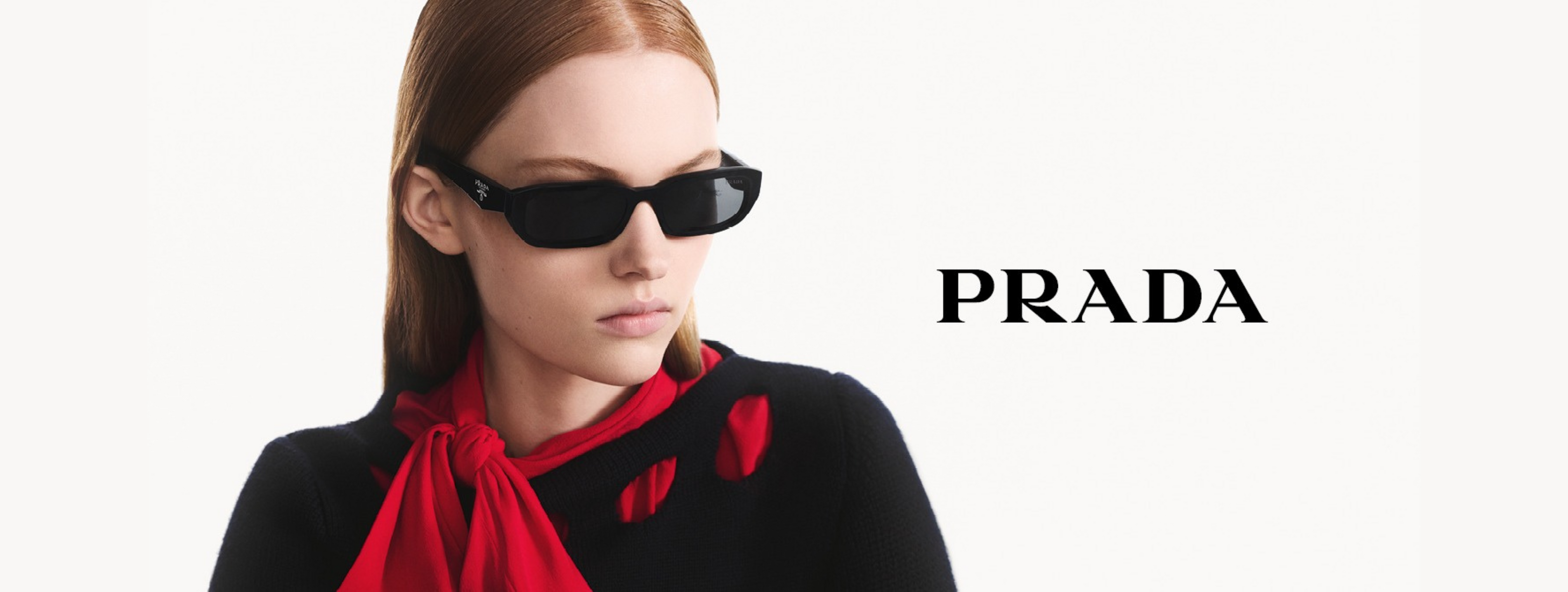 Woman wearing Prada sunglasses with a red scarf, on a white background