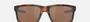 Oakley Mainlink 49 rectangular sunglasses for men in full rim plastic, with brown frame, and brown lenses. 61mm in lens size, 17mm in bridge size, and 138mm in temple length.