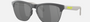 Oakley Frogskins Lite 51 round sunglasses for men in semi-rimless plastic, with grey frame, and black lenses. 63mm in lens size, 10mm in bridge size, and 138mm in temple length.