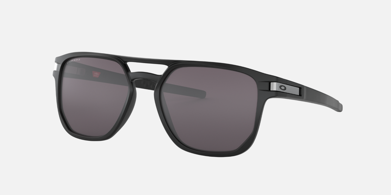Oakley Latch Beta 01 rectangular sunglasses for men in full rim plastic, with black frame, and grey lenses. 54mm in lens size, 18mm in bridge size, and 140mm in temple length.