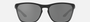 Oakley Manorburn 02 rectangular sunglasses for men in full rim plastic, with black frame, and black lenses. 56mm in lens size, 17mm in bridge size, and 149mm in temple length.