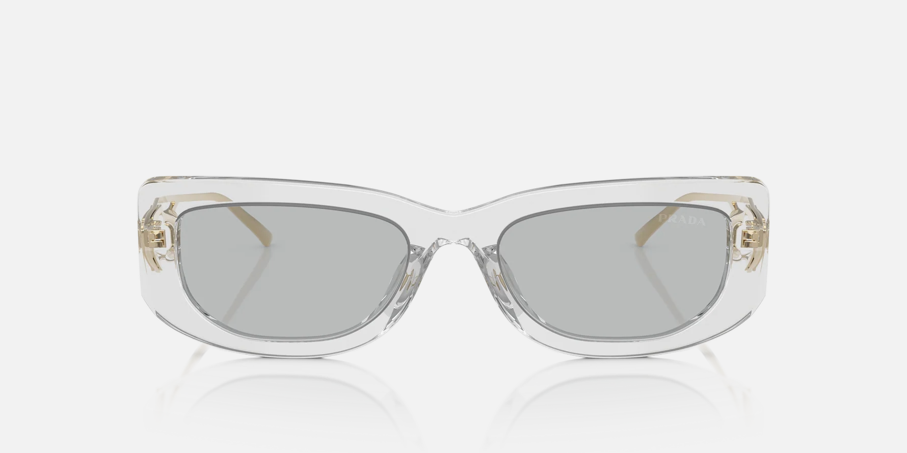 Prada PR 14YS 12R50K rectangular sunglasses for women in full rim acetate, with transparent grey frame, and light grey lenses. 53mm in lens size, 19mm in bridge size, and 140mm in temple length.