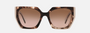 Prada PR 15WS 01R0A6 irregular sunglasses for women in full rim acetate, with havana frame, and brown gradient lenses. 54mm in lens size, 19mm in bridge size, and 140mm in temple length.