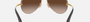 Ray-Ban RB3449 001/13 pilot sunglasses for unisex in semi-rimless metal, with arista gold frame, and brown gradient lenses. 59mm in lens size, 14mm in bridge size, and 135mm in temple length.
