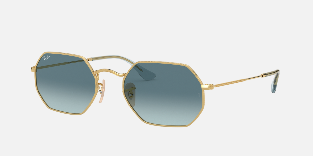 Ray-Ban Octagonal Classic RB3556N 91233M octagonal sunglasses for unisex in full rim metal, with gold frame, and blue gradient lenses. 53mm in lens size, 21mm in bridge size, and 145mm in temple length.