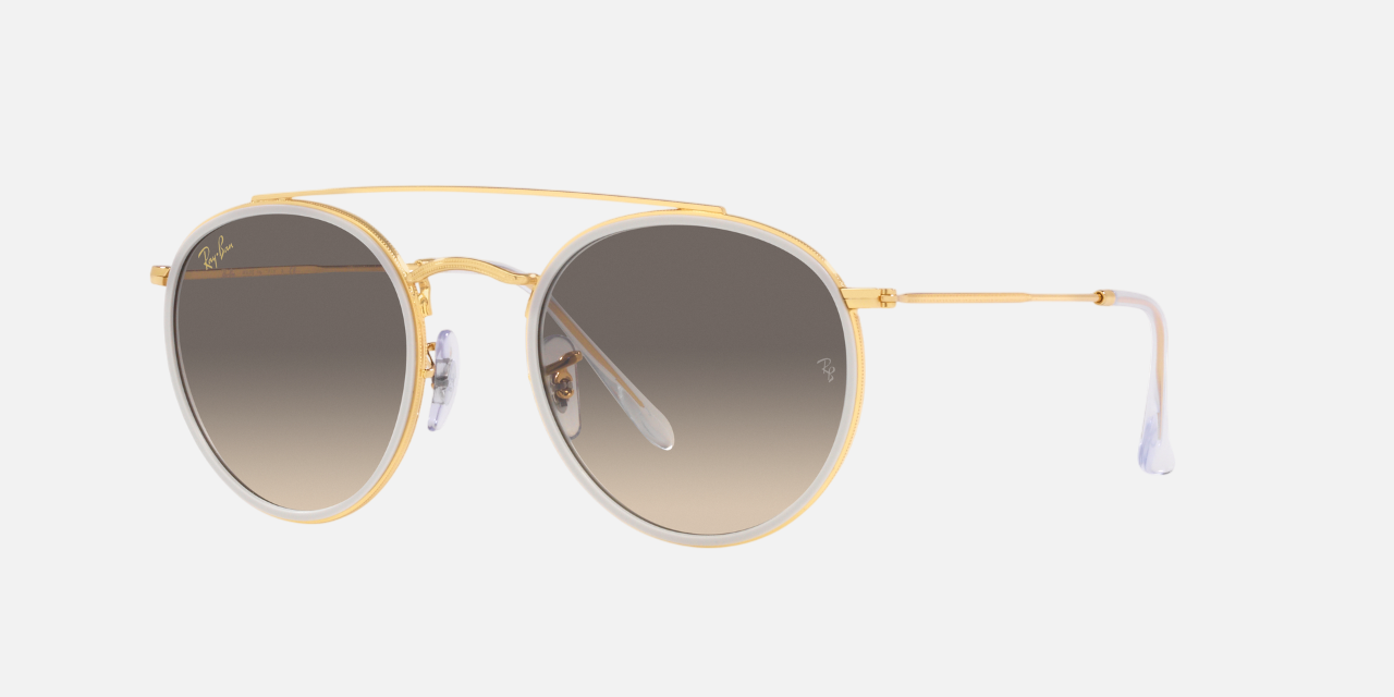 Ray-Ban Round Double Bridge RB3647N 923632 unisex's full rim round sunglasses in a polished gold metal frame with clear grey lenses. Features a 51 mm lens size, 22 mm bridge size, and 145 mm temple length. Available in Dubai, UAE.