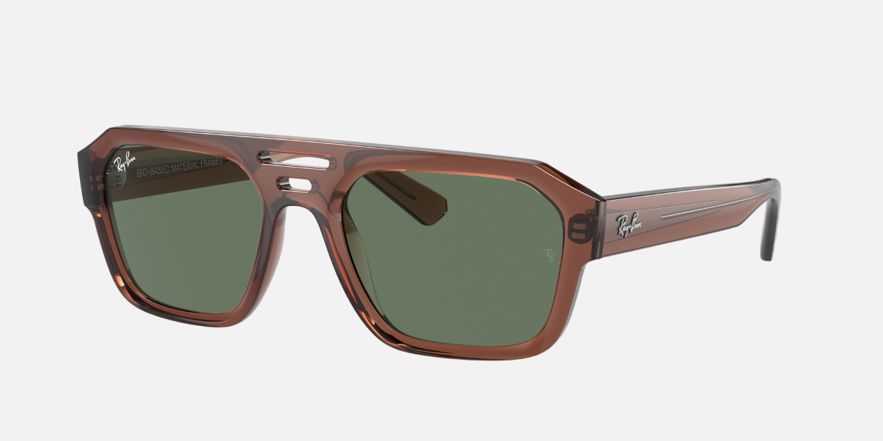 Ray-Ban Corrigan Bio-Based RB4397 667882 unisex's full rim irregular sunglasses in a polished transparent brown molded acetate frame with dark green lenses. Features a 54 mm lens size, 20 mm bridge size, and 145 mm temple length. Available in Dubai, UAE.