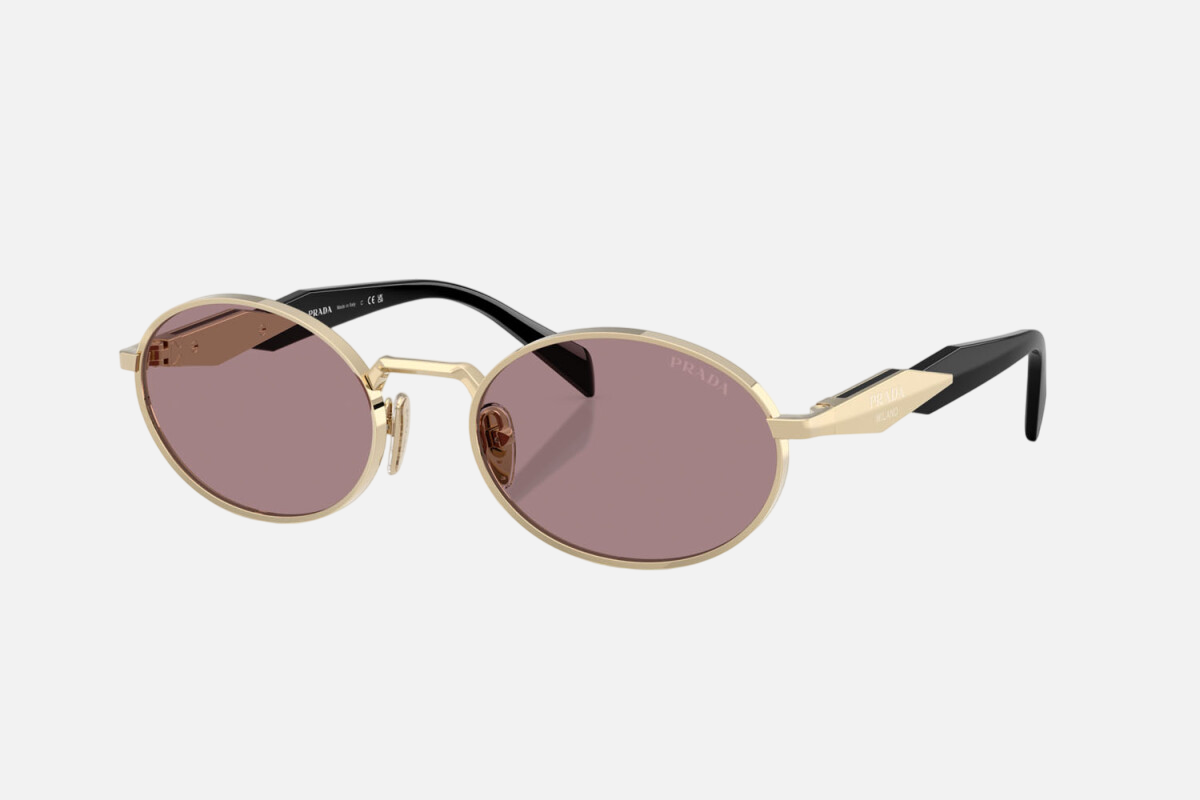 Prada PR 65ZS ZVN20I oval sunglasses for women in full rim metal, with pale gold frame, and light purple lenses. 55mm in lens size, 20mm in bridge size, and 140mm in temple length.