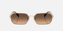 Prada PR A51S ZVN50C irregular sunglasses for women in full rim metal, with pale gold frame, and brown with grey gradient lenses. 58mm in lens size, 17mm in bridge size, and 140mm in temple length.