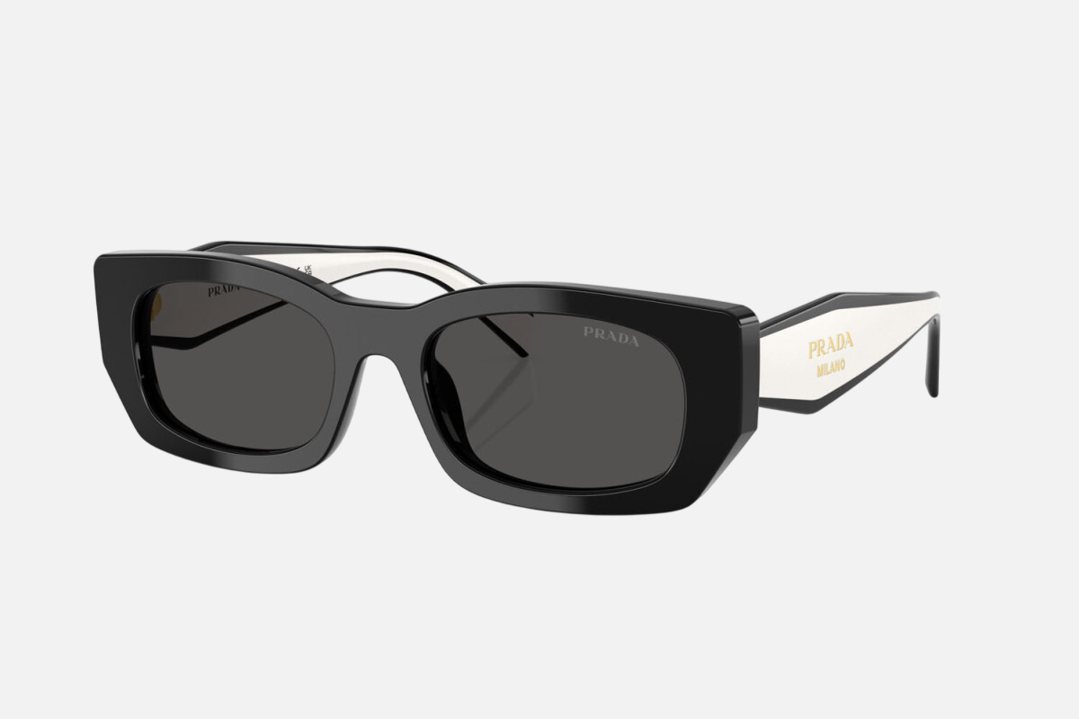 Prada PR B05S 09Q08Z pillow sunglasses for women in full rim acetate, with black frame, and dark grey lenses. 53mm in lens size, 19mm in bridge size, and 140mm in temple length.