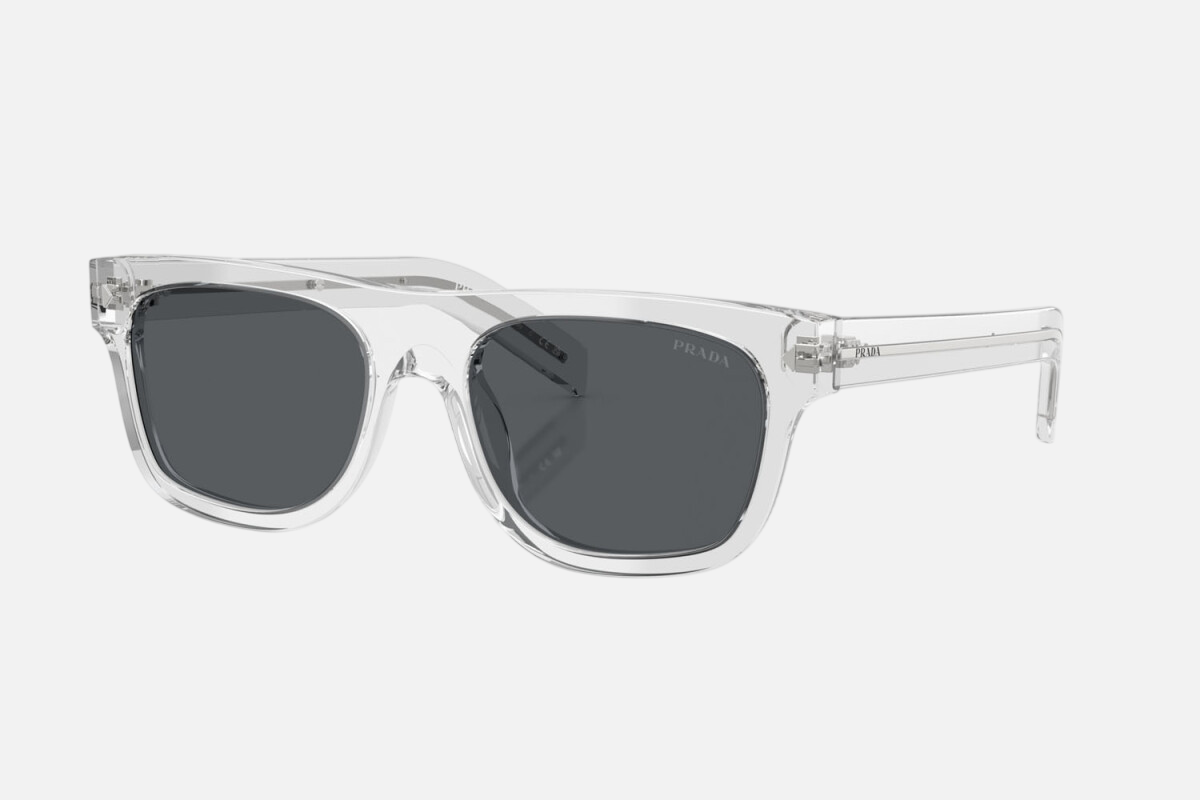 Prada PR B12S 12R07T square sunglasses for men in full rim acetate, with transparent grey frame, and dark blue lenses. 55mm in lens size, 19mm in bridge size, and 145mm in temple length.