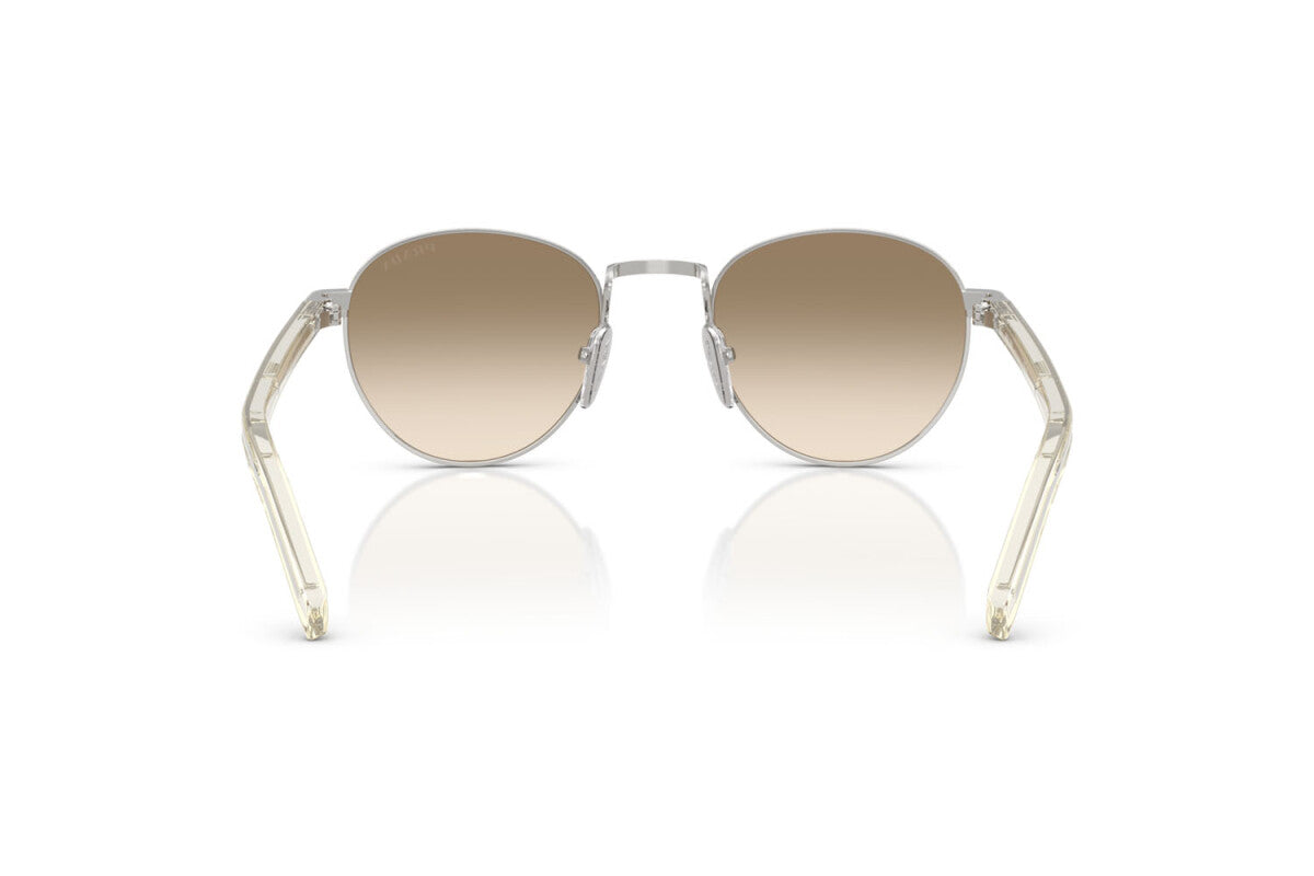 Prada PR B52S 1BC80K round sunglasses for women in full rim steel, with silver frame, and light yellow with brown lenses. 49mm in lens size, 21mm in bridge size, and 145mm in temple length.