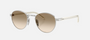 Prada PR B52S 1BC80K round sunglasses for women in full rim steel, with silver frame, and light yellow with brown lenses. 49mm in lens size, 21mm in bridge size, and 145mm in temple length.