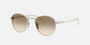 Prada PR B52S 1BC80K round sunglasses for women in full rim steel, with silver frame, and light yellow with brown lenses. 49mm in lens size, 21mm in bridge size, and 145mm in temple length.