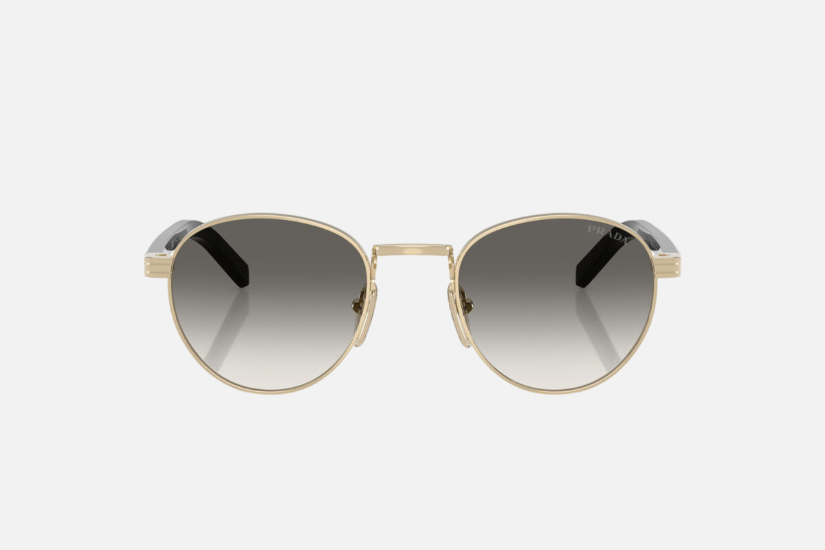 Prada PR B52S ZVN02C round sunglasses for women in full rim steel, with pale gold frame, and grey gradient lenses. 49mm in lens size, 21mm in bridge size, and 145mm in temple length.