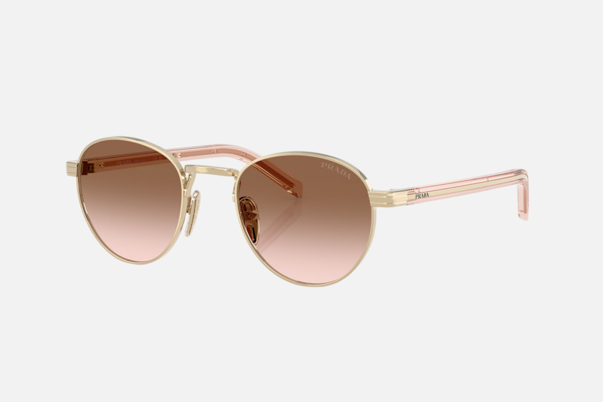 Prada PR B52S ZVN0A6 round sunglasses for women in full rim steel, with pale gold frame, and brown gradient lenses. 49mm in lens size, 21mm in bridge size, and 145mm in temple length.