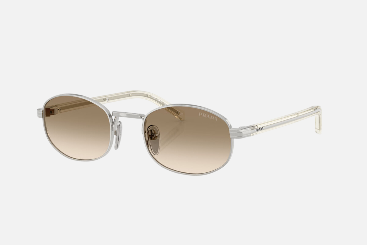 Prada PR B53S 1BC80K oval sunglasses for women in full rim steel, with silver frame, and light yellow with brown lenses. 52mm in lens size, 21mm in bridge size, and 145mm in temple length.