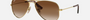 Ray-Ban Junior Aviator Kids RJ9506S 223/13 pilot sunglasses for kids in full rim metal, with polished arista gold frame, and brown lenses. 52mm in lens size, 14mm in bridge size, and 125mm in temple length.