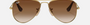 Ray-Ban Junior Aviator Kids RJ9506S 223/13 pilot sunglasses for kids in full rim metal, with polished arista gold frame, and brown lenses. 52mm in lens size, 14mm in bridge size, and 125mm in temple length.