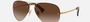 Ray-Ban RB3449 001/13 pilot sunglasses for unisex in semi-rimless metal, with arista gold frame, and brown gradient lenses. 59mm in lens size, 14mm in bridge size, and 135mm in temple length.