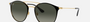 Ray-Ban RB3546 187/71 round sunglasses for women in full rim metal, with black on gold frame, and grey gradient lenses. 52mm in lens size, 20mm in bridge size, and 145mm in temple length.