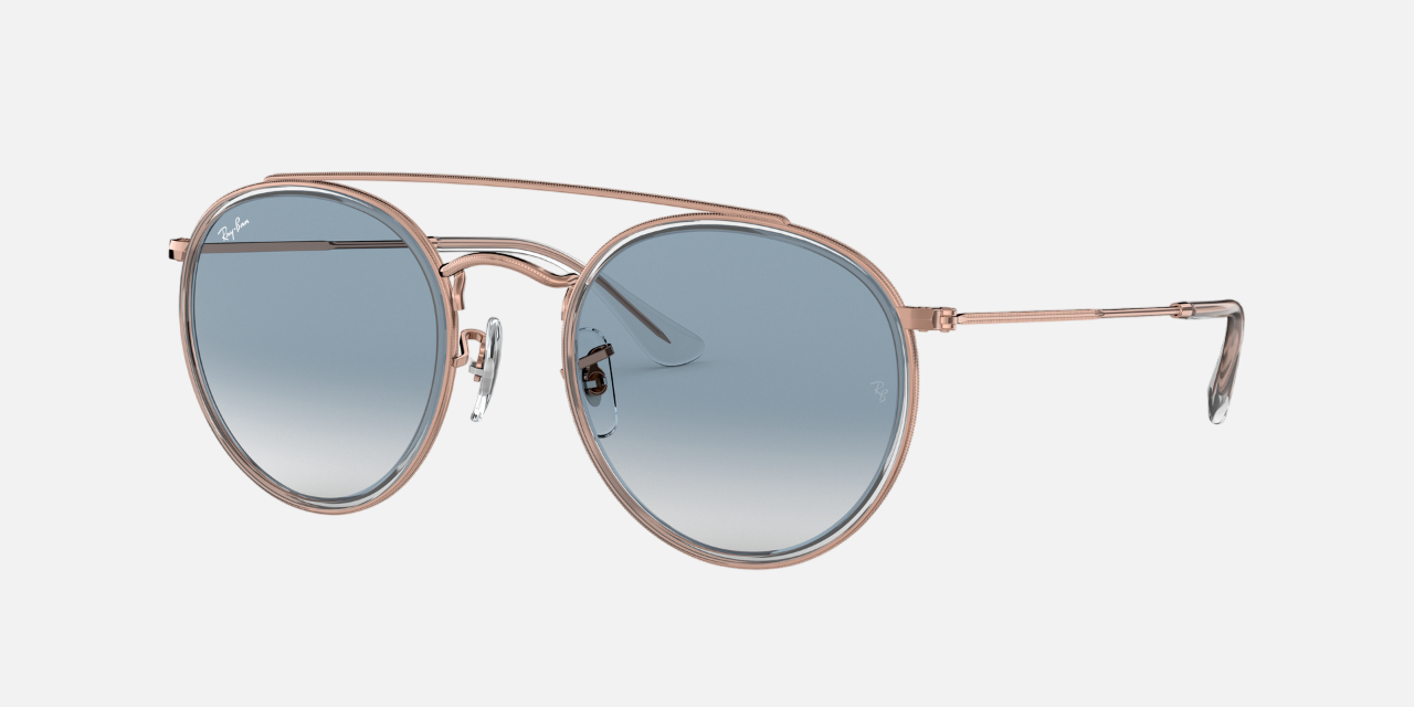 Ray-Ban Round Double Bridge RB3647N 90683F unisex's full rim round double bridge sunglasses in a copper metal frame with light blue gradient lenses. Features a 51 mm lens size, 22 mm bridge size, and 145 mm temple length. Available in Dubai, UAE.