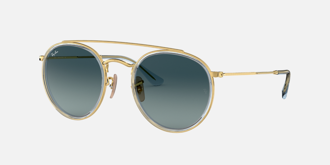 Ray-Ban Round Double Bridge RB3647N 91233M unisex's full rim round double bridge sunglasses in a gold metal frame with blue gradient lenses. Features a 51 mm lens size, 22 mm bridge size, and 145 mm temple length. Available in Dubai, UAE.