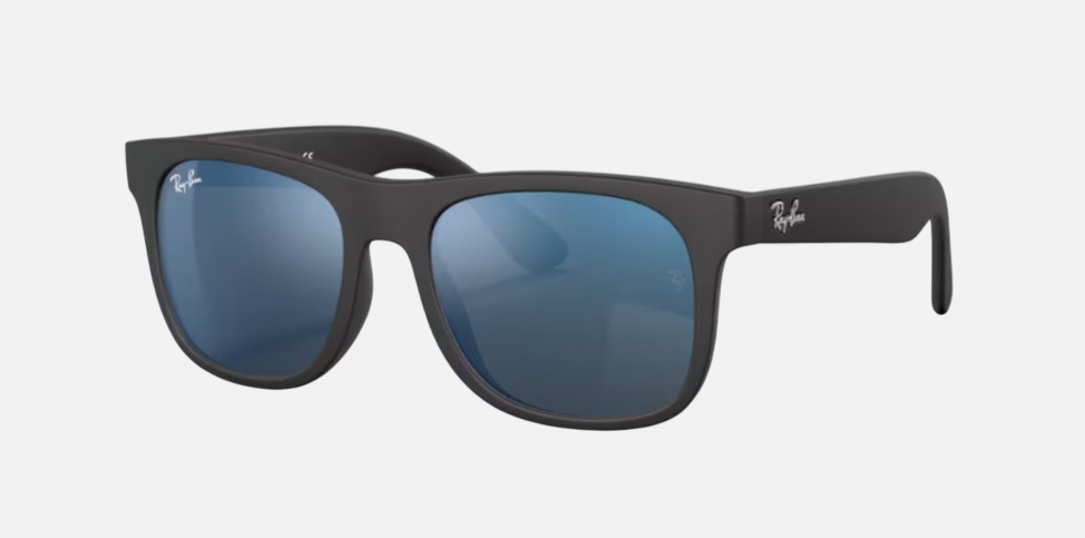 Ray-Ban Junior Justin Kids RJ9069S 702855 square sunglasses for kids in full rim injected, with matte rubber black frame, and blue mirror lenses. 48mm in lens size, 16mm in bridge size, and 130mm in temple length.