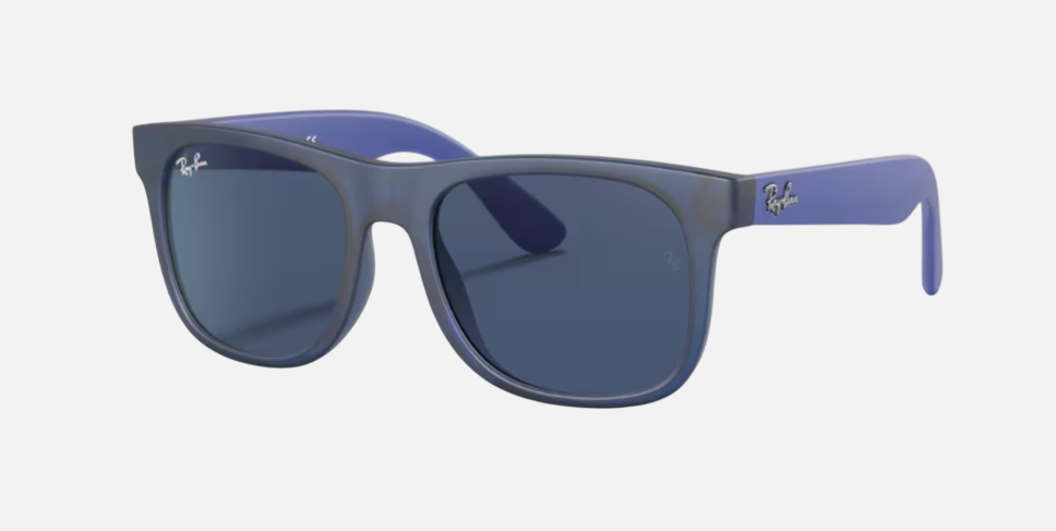 Ray-Ban Junior Justin Kids RJ9069S 706080 square sunglasses for kids in full rim injected, with matte transparent blue frame, and dark blue lenses. 48mm in lens size, 16mm in bridge size, and 130mm in temple length.