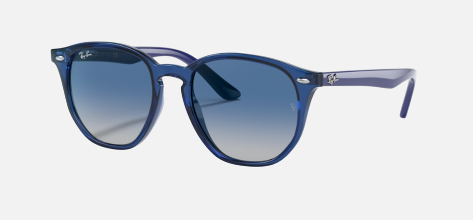 Ray-Ban Junior RJ9070S 70624L irregular sunglasses for kids in full rim injected, with polished transparent blue frame, and grey gradient blue lenses. 46mm in lens size, 16mm in bridge size, and 130mm in temple length.