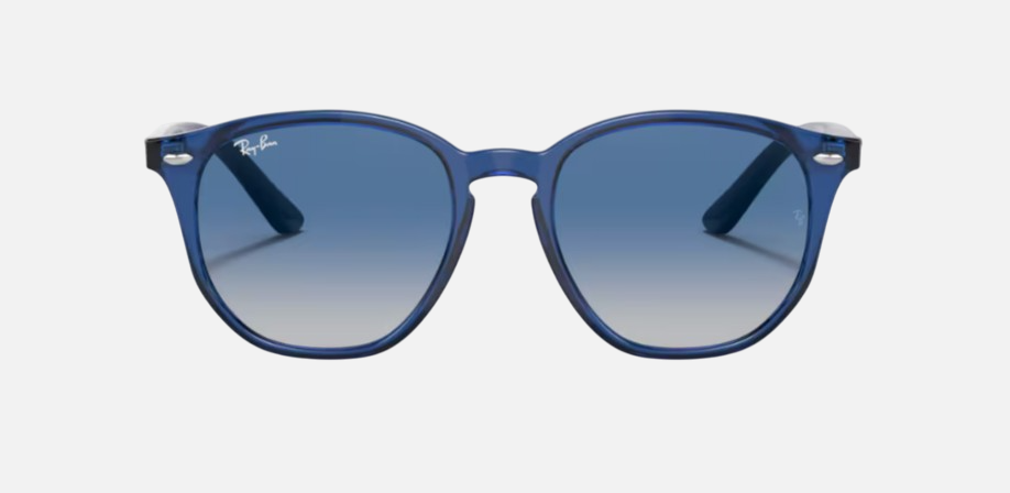 Ray-Ban Junior RJ9070S 70624L irregular sunglasses for kids in full rim injected, with polished transparent blue frame, and grey gradient blue lenses. 46mm in lens size, 16mm in bridge size, and 130mm in temple length.