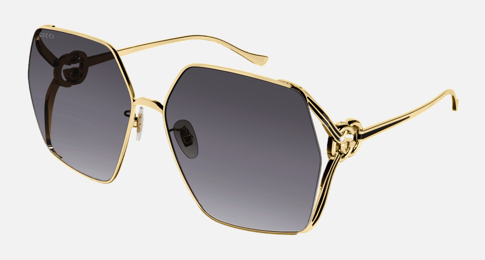 Gucci GG1322SA 001 oversized sunglasses for women in full rim metal, with gold frame, and grey gradient lenses. 64mm in lens size, 16mm in bridge size, and 135mm in temple length.
