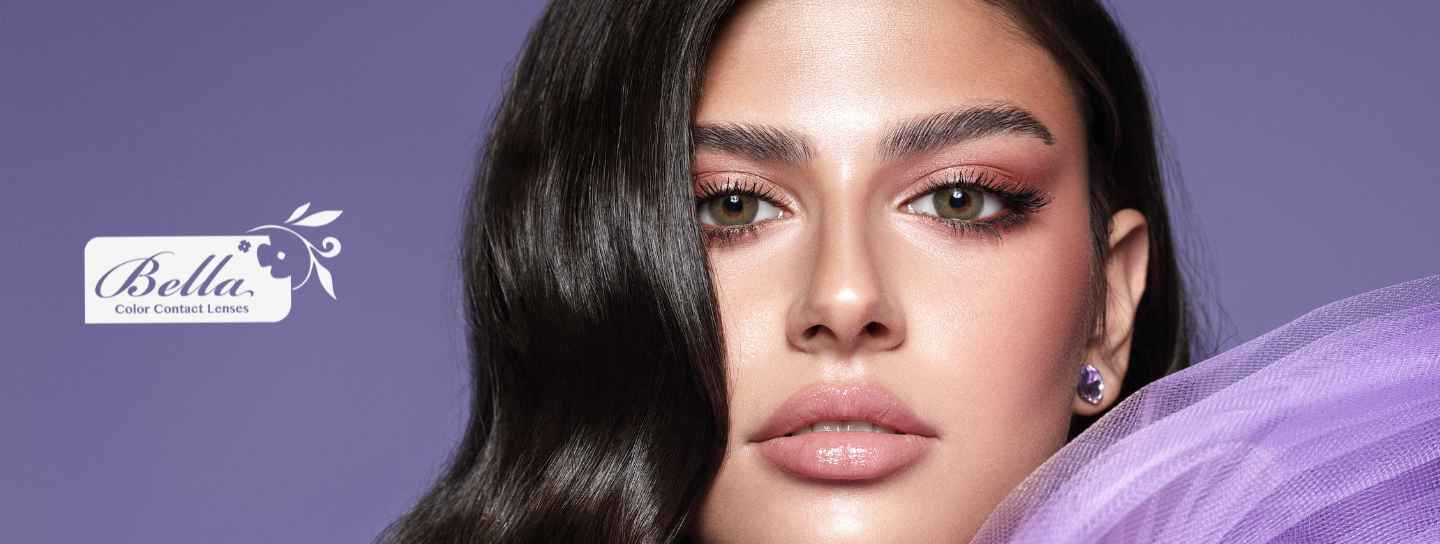 Woman wearing a green Bella contact lenses and purple fabric against a purple background with Bella logo at the left.