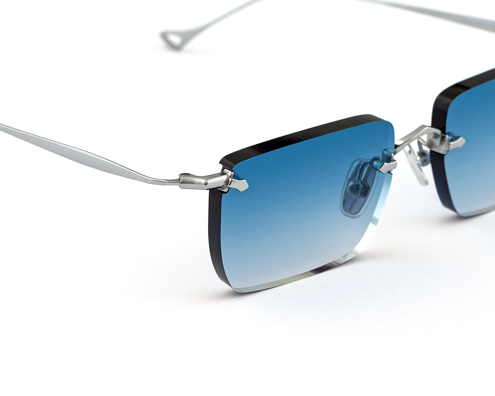 Eyepetizer Etherege C.1-53 rectangular sunglasses for unisex in rimless steel, with silver frame, and blue gradient lenses. 52mm in lens size, 18mm in bridge size, and 145mm in temple length.