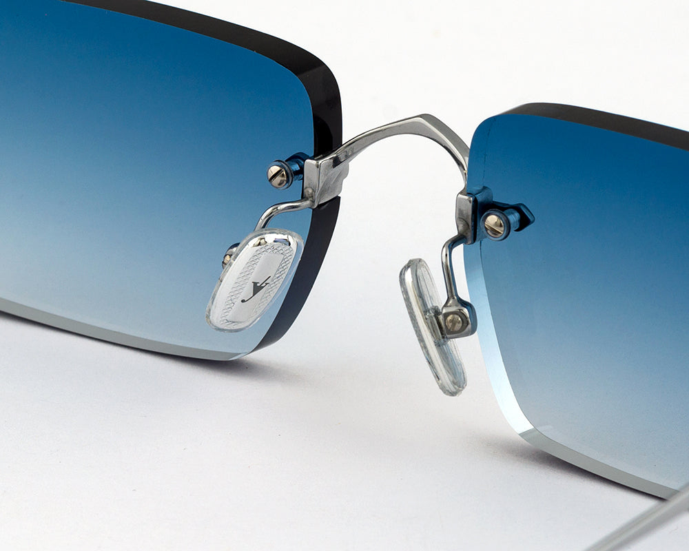 Eyepetizer Etherege C.1-53 rectangular sunglasses for unisex in rimless steel, with silver frame, and blue gradient lenses. 52mm in lens size, 18mm in bridge size, and 145mm in temple length.