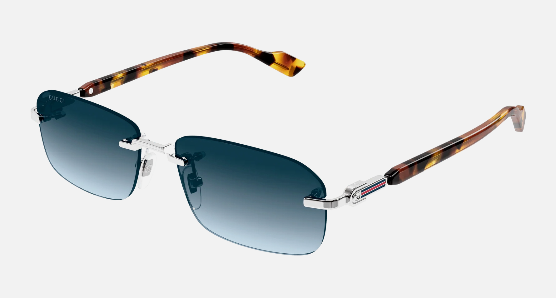 Gucci GG1221S 007 men's rimless rectangle sunglasses in a silver metal frame with blue lenses. Features a 56 mm lens size, 16 mm bridge size, and 140 mm temple length. Available in Dubai, UAE.