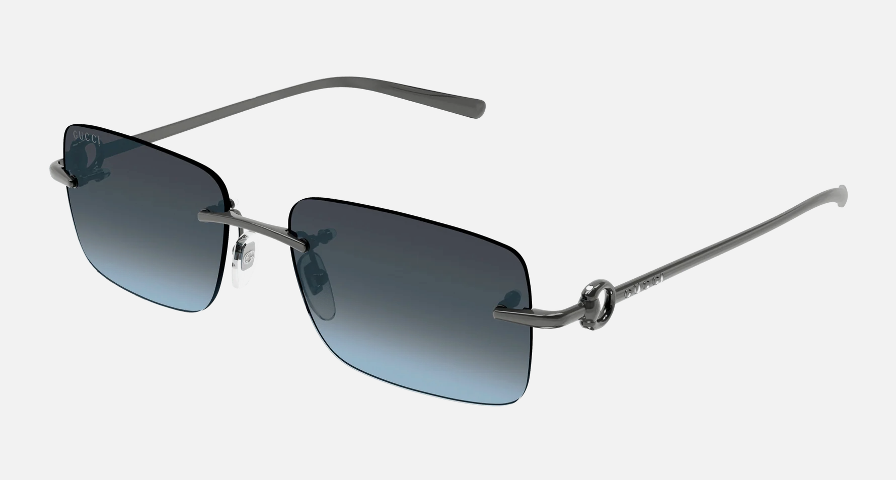 Gucci GG1703S 006 men's rimless rectangle sunglasses in a gunmetal metal frame with blue lenses. Features a 55 mm lens size, 17 mm bridge size, and 140 mm temple length. Available in Dubai, UAE.