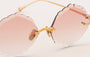 Eyepetizer Guadalupe C.4-61 irregular sunglasses for women in rimless steel, with gold frame, and orange gradient lenses. 56mm in lens size, 16mm in bridge size, and 145mm in temple length.
