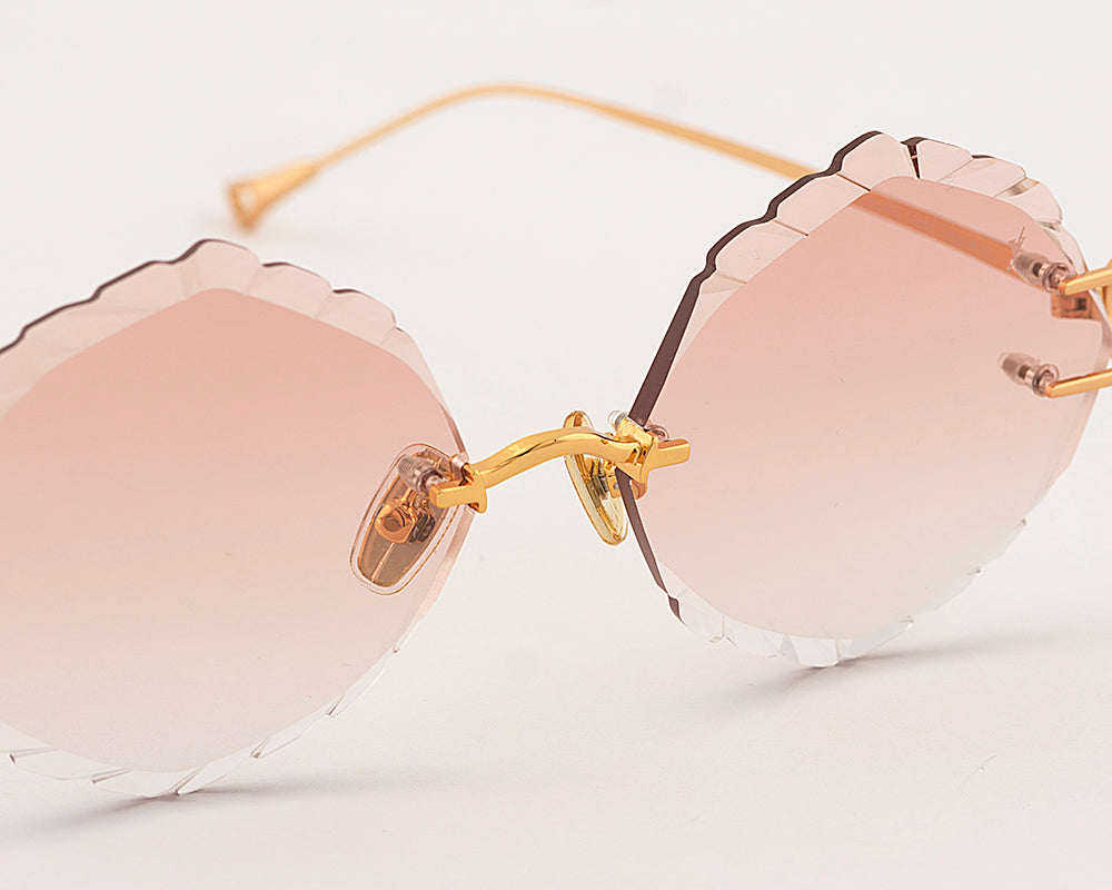 Eyepetizer Guadalupe C.4-61 irregular sunglasses for women in rimless steel, with gold frame, and orange gradient lenses. 56mm in lens size, 16mm in bridge size, and 145mm in temple length.