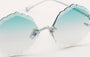 Eyepetizer Guadalupe C.1-59 irregular sunglasses for women in rimless steel, with silver frame, and gradient aqua green lenses. 56mm in lens size, 16mm in bridge size, and 145mm in temple length.