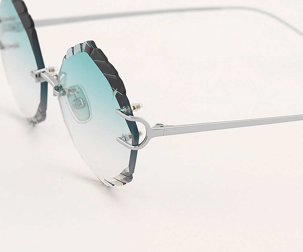 Eyepetizer Guadalupe C.1-59 irregular sunglasses for women in rimless steel, with silver frame, and gradient aqua green lenses. 56mm in lens size, 16mm in bridge size, and 145mm in temple length.