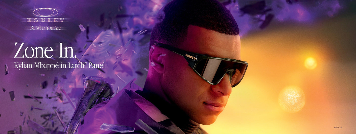 Model Kylian Mbappe wearing an Oakley black sunglasses with purple and orange background and with a text "Oakley Be Who You Are" and "Zone In."