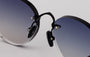 Eyepetizer Oxford C.6-51 round sunglasses for unisex in rimless steel, with black frame, and grey lenses. 51mm in lens size, 18mm in bridge size, and 145mm in temple length.
