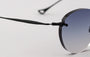 Eyepetizer Oxford C.6-51 round sunglasses for unisex in rimless steel, with black frame, and grey lenses. 51mm in lens size, 18mm in bridge size, and 145mm in temple length.
