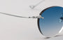 Eyepetizer Oxford C.1-53 round sunglasses for unisex in rimless steel, with silver frame, and blue gradient lenses. 51mm in lens size, 18mm in bridge size, and 145mm in temple length.