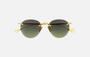Eyepetizer Oxford C.4-52 round sunglasses for women in rimless steel, with gold frame, and green lenses. 51mm in lens size, 18mm in bridge size, and 145mm in temple length.