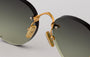 Eyepetizer Oxford C.4-52 round sunglasses for women in rimless steel, with gold frame, and green lenses. 51mm in lens size, 18mm in bridge size, and 145mm in temple length.
